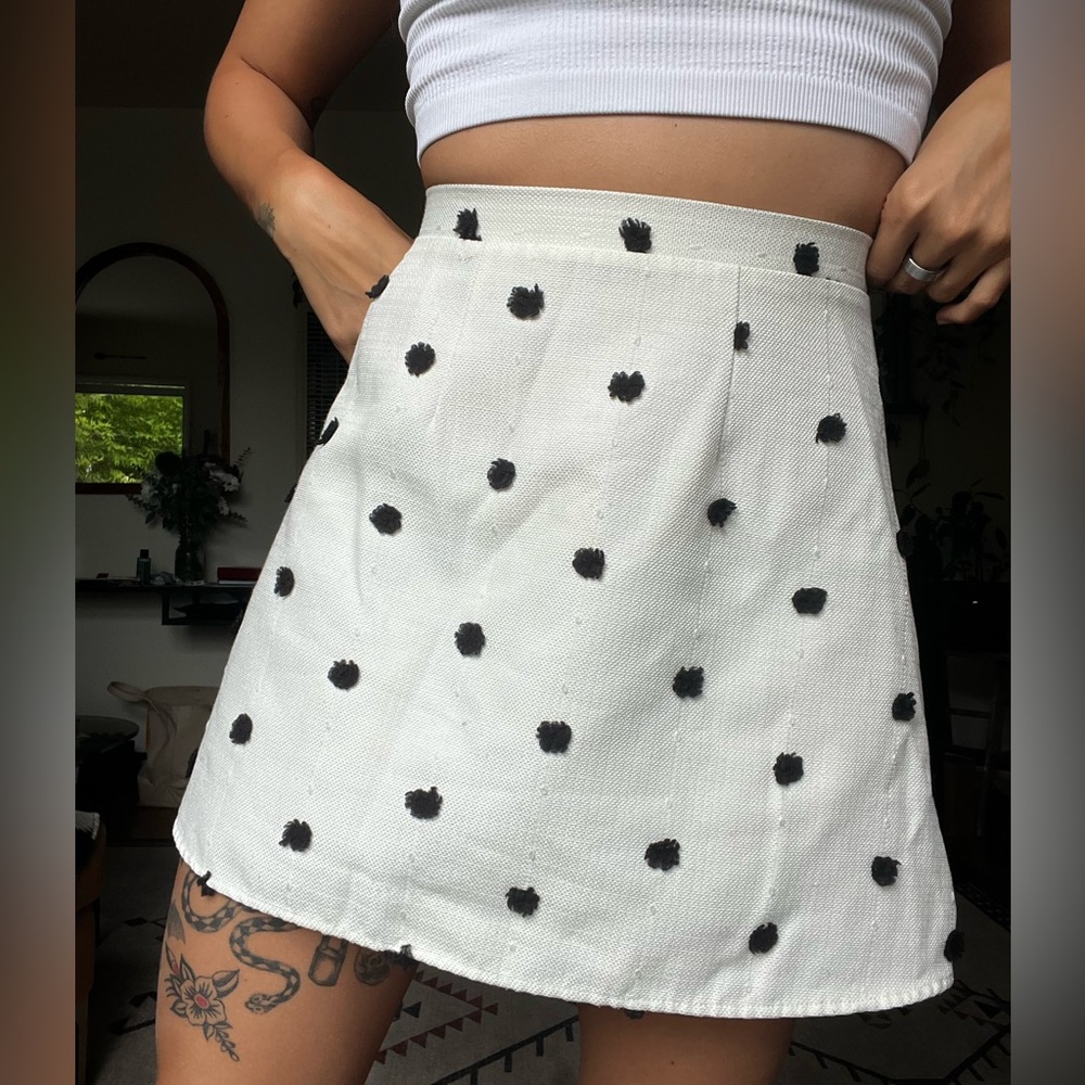 White Textured linen A Line skirt darted with black pompoms.